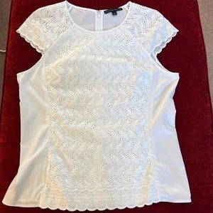 Nice top. 97% cotton 3% Lycra Spandex. Machine wash.  Maybe worn once.